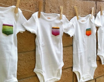 Baby onesie with serape pocket detail