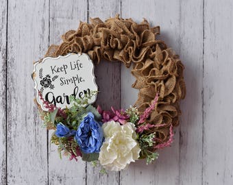 Burlap Wreath with blue, cream and pink flowers and a vintage rustic sign
