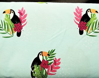 Fabric cotton jersey printed patterns "toucan" on a blue sky/green background