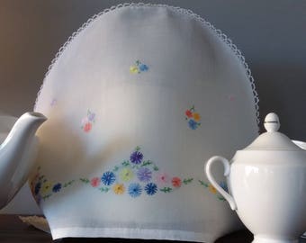 Vintage white tea cosie cover with hand embroidered flowers