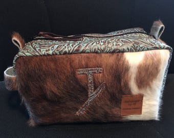 Cowhide and leather makeup or shaving bag.