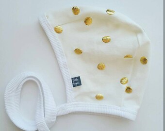 Cream gold metallic dot pilot hat by Little Lapsi. Baby hat with ties.