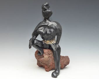 Black and Gold Abstract Buddha Kwan Yin Sitting on a Rock