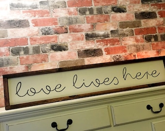 Love lives here painted wood sign