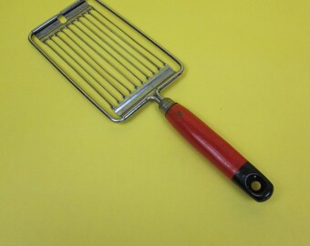 Vintage Tomado tomato slicer. Red and black wooden handle. Vintage kitchen utensil.