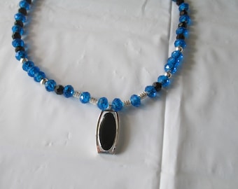 Black/silver pendant on deep blue necklace