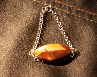 Fossil Peanutwood pendant with Sterling Silver Chain.