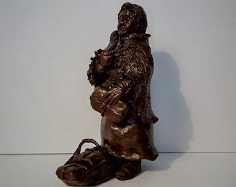 Old women with basket clay sculpture