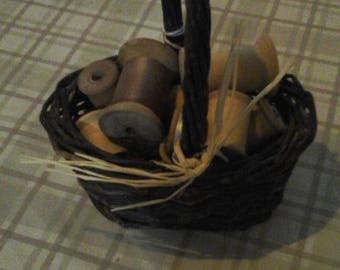 Vintage wooden spools in a basket