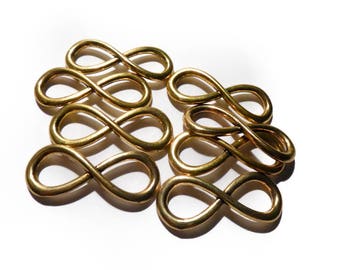 A set of 8 large gold infinity design pendant