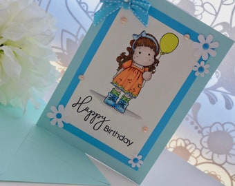 Blue handmade, hand stamped, hand coloured birthday card with Magnolia Tilda image with balloon