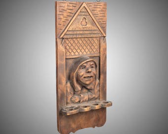 carved wood Monk in window pipe rack
