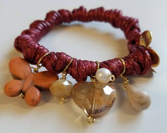 Knotted bracelet with charms