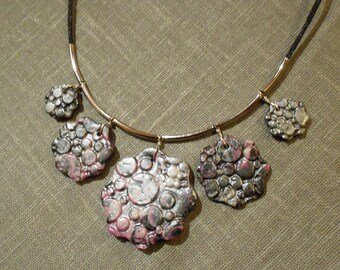 Beautiful necklace of polymer clay flowers.