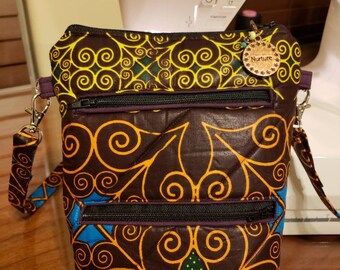 Beautiful African Inspired Multi Colored Crossbody Bag - Fully lined, quilted with 2 exterior zippered pockets as well as 1 inner pocket.