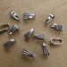 Set of 10 bails pinch 8.5 mm x 3.5 mm stainless steel.