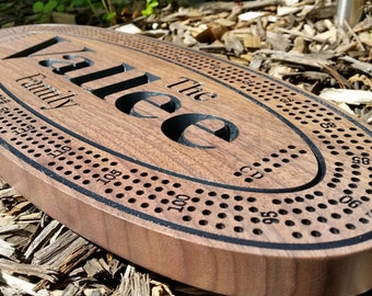 Beautifully crafted, black walnut, Cribbage board. Four run board with 12 metal pegs. Personalized with the names of your choice.