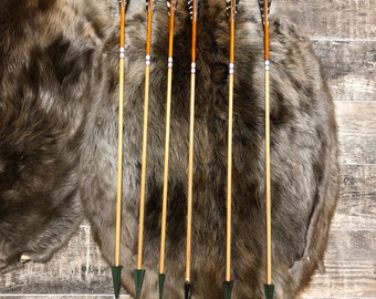 Hand made port orford cedar hunting arrows. 30" from tip of nock to the top of the broadheads. 45-50 lb spine weight. 125 grain broadhead