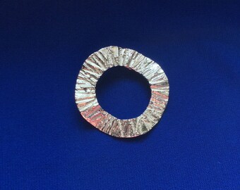 Pendant, sterling silver, versatile wavy textured donut, showy