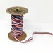 Vintage Ribbonette paper red white blue stripe ribbon on metal spool Chicago