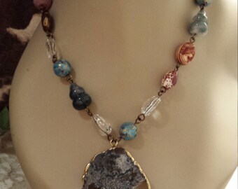 One strand assorted beaded faceted necklace with center drop