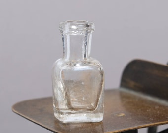 Antique miniature clear glass bottle, medical or laboratory bottle.