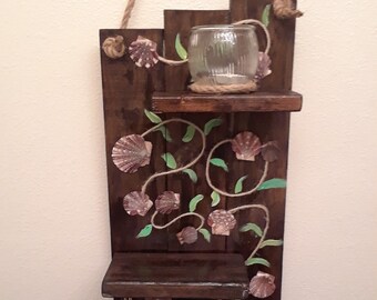 Rustic wooden shelves decorated with seashells