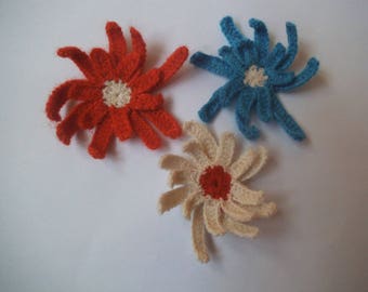 Crocheted blue, off-white and orange flowers
