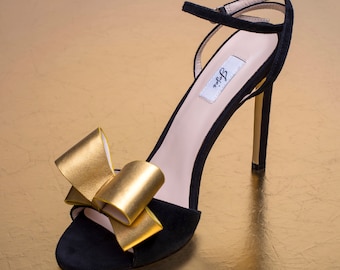 Black high heel sandal with big gold bow