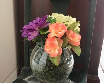 Purple, yellow and orange flowers/round glass vase