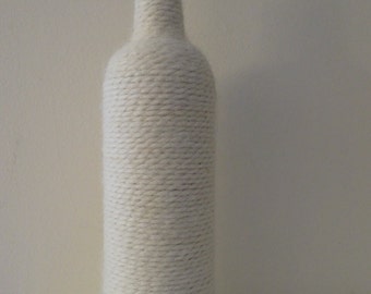 Yarn wrapped wine bottle in white