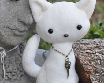 Cat Plush with bird skull pendant