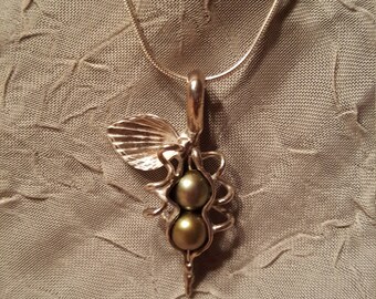 Sterling silver necklace with a unique 2 green fresh water peas in a pod.