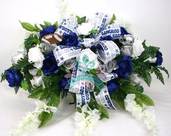 Dallas Cowboy's Cemetery Graveside Saddle Arrangement w Silver and Blue Roses with White Wisteria