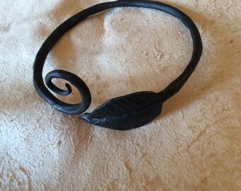 Hand forged metal bangle bracelet (adjustable). Leaf on right.