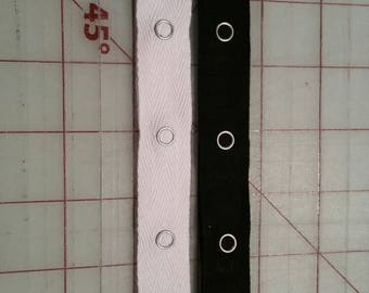 Snap tape. Black or white. Snaps 1.5 inches apart.