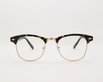 Clubmaster style browline, clear lens, half frame glasses. Tortoise and gold frame spectacles. Prescription horn rimmed eyeglasses.