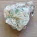 Raw green fluorite chunk with rainbows