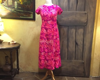 1970s Hawaiian dress in a bright pink floral tropical print