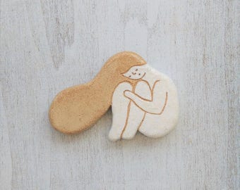 They are rounded and clay brooch