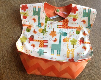 Snappy Pocket Bib, Waterproof Laminate, Giraffe Crossing for boys and girls, Reversible and adjustable, BPA Free, wipeable and washable