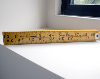 yellow plastic rabone folding ruler tool