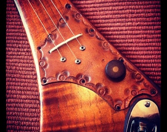 Three string electric diddley bow by DaShtick guitars.