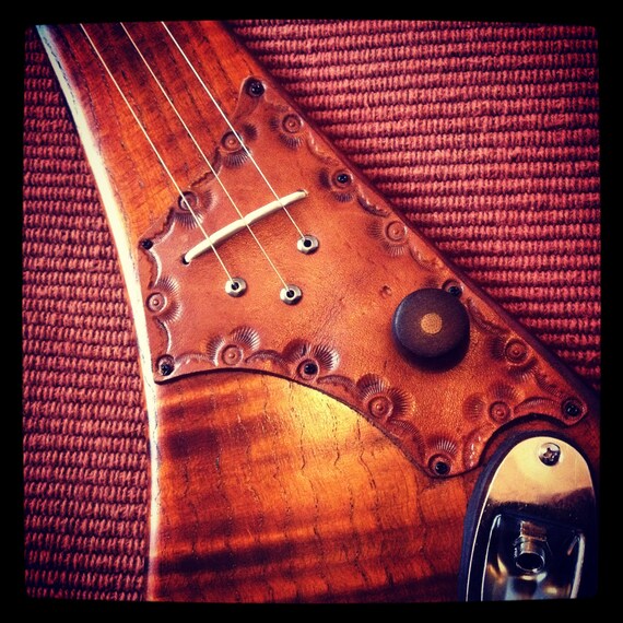 Three string electric diddley bow by DaShtick guitars.