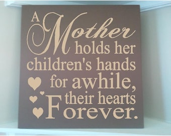Personalized wooden sign w vinyl quote...A mother holds her children's hands for a while their hearts forever