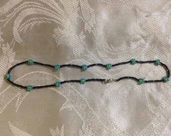 Black necklace with turquoise flowers