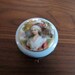 Antique porcelain pale blue hinged trinket box with gilding and Edwardian style portrait blue gold red green brown