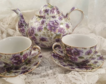 Chintz violets teapot with two teacups and saucers