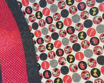 Minnie Mouse print in all cotton.the backing is a white cotton, and Machine quilted by me. An heirloom qualit