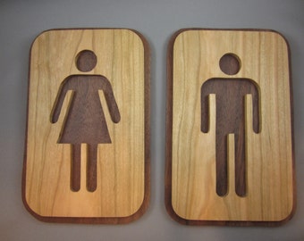 A Pair of His and Hers Bathroom Signs